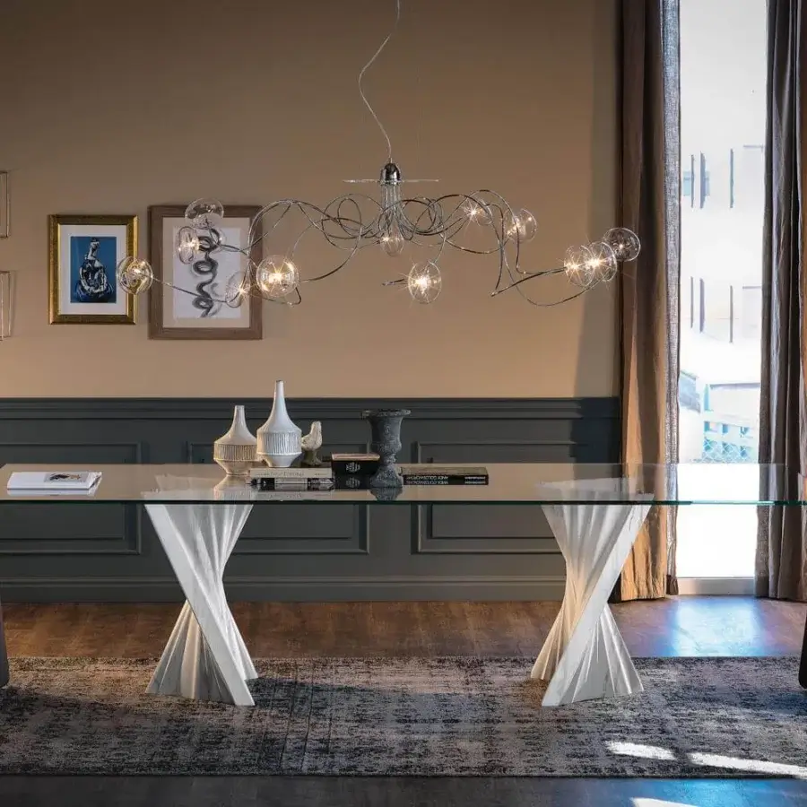Elegant Cattelan Italia Plisset table with a clear glass top and matt Palissandro white marble base crafted in a twisted form
