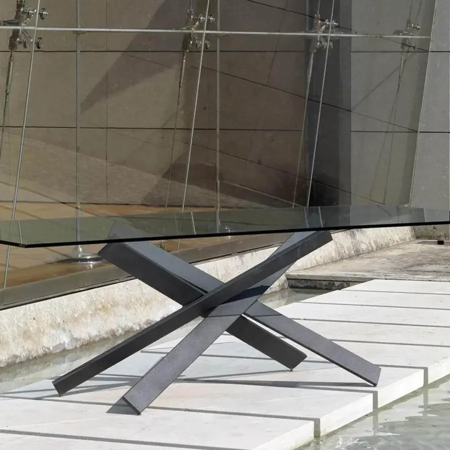 Luxury Reflex Mikado table with transparent glass top and dark gray polished iron base