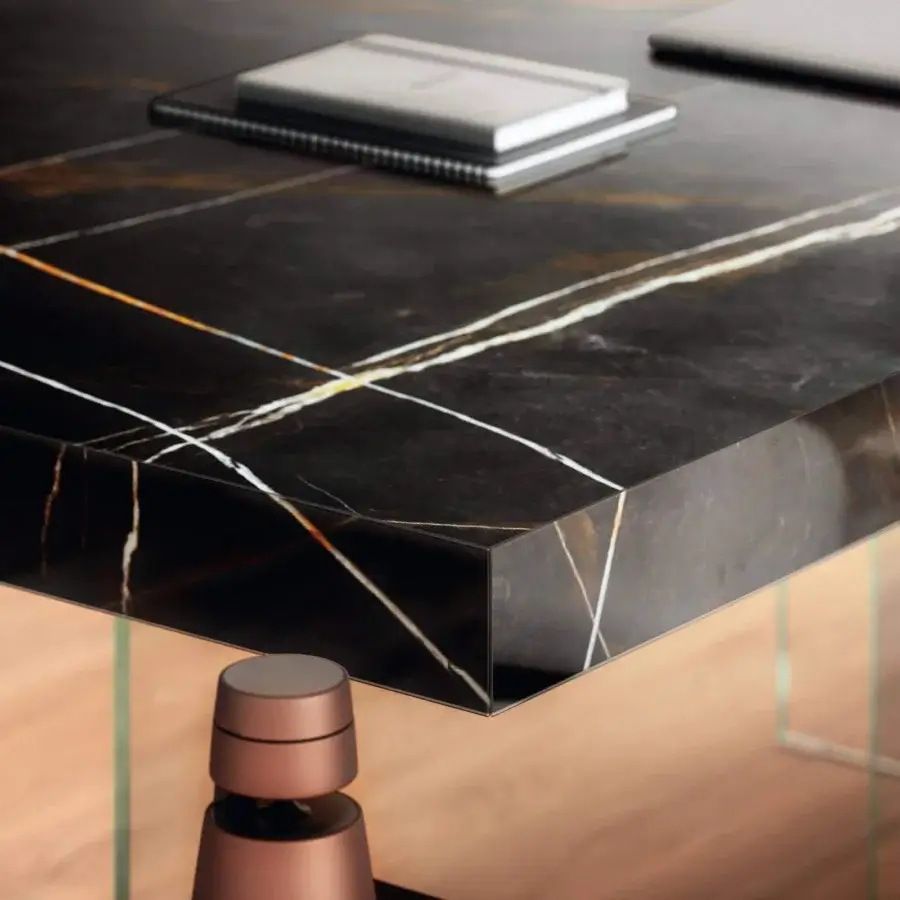 Distinguished Lago Air table with dark XGlass tabletop and transparent tempered-glass supports exhibiting white and gold veining in a glossy finish