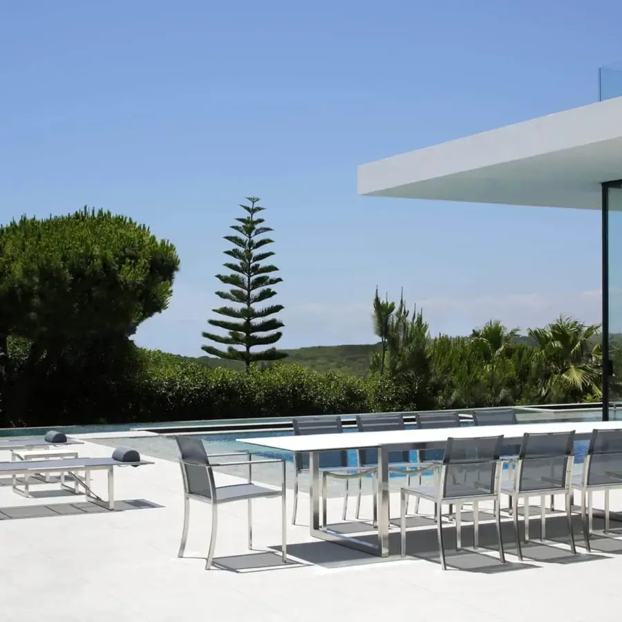 Elegant Royal Botania Ninix extendable table with a solid white top and polished reflective metal base