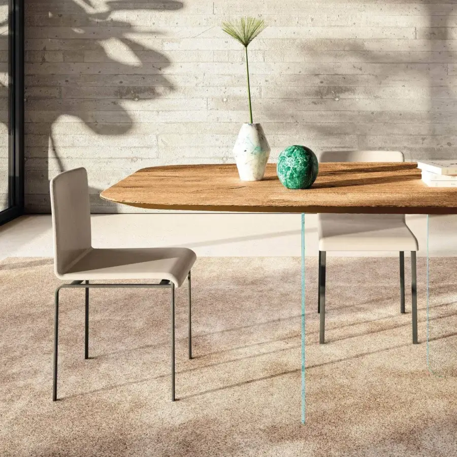 Distinguished Lago Air Soft Shaped table with dark metal legs supporting a rounded wood top in a light brown natural finish