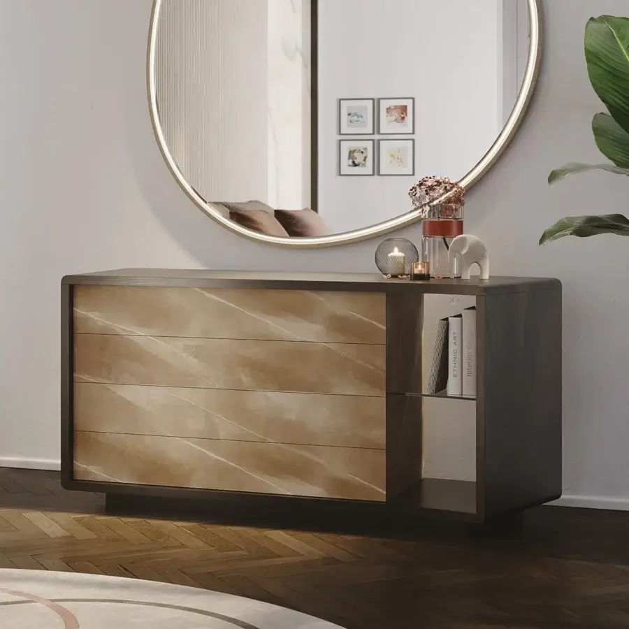 Reflex space dresser, marble-effect top, dark gray base, curved asymmetrical design with brushed gold pull, styled with glass sphere, vase, books.