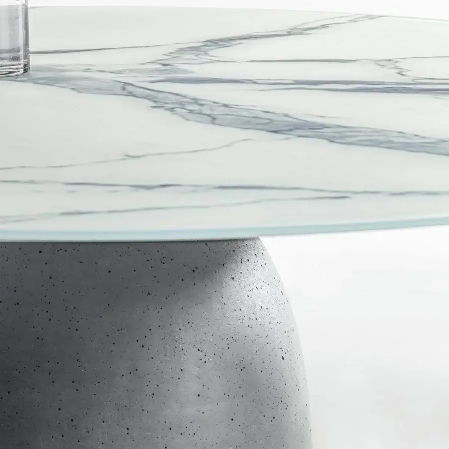 Distinguished Lago Janeiro table with concrete base and textured anthracite finish, showcasing white layered surface with glass edge