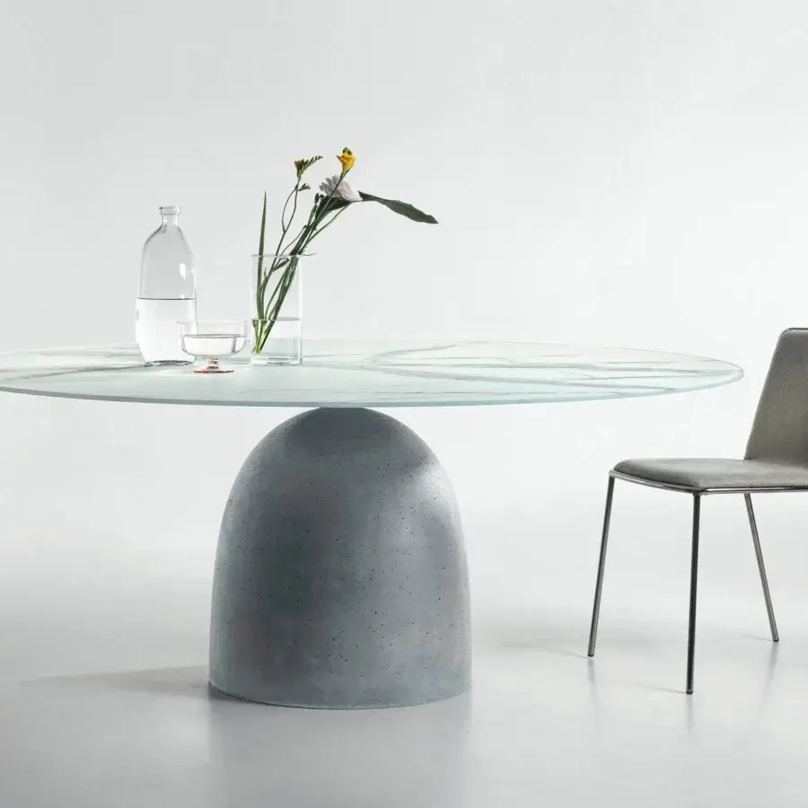 Exceptional Lago Janeiro table with unique concrete base in natural anthracite finish and glass tabletop with subtle grey veining