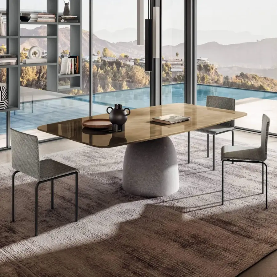 Distinguished Lago Janeiro table with brownish glass top and natural anthracite textured concrete base