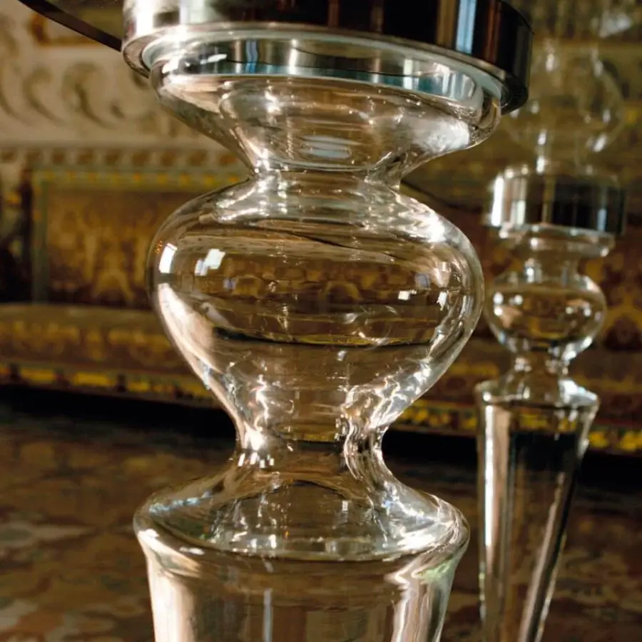 Distinctive Reflex Gran Canal table with transparent glass top and unique hourglass-shaped Murano glass base crafted in Italy