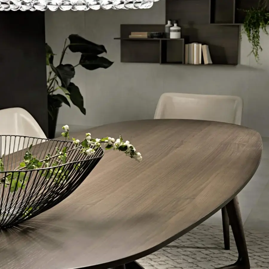 Distinguished Pacini & Cappellini Cover table with oval veneered ash wood top and inclined solid ash wood base in warm brown tones with matte finish