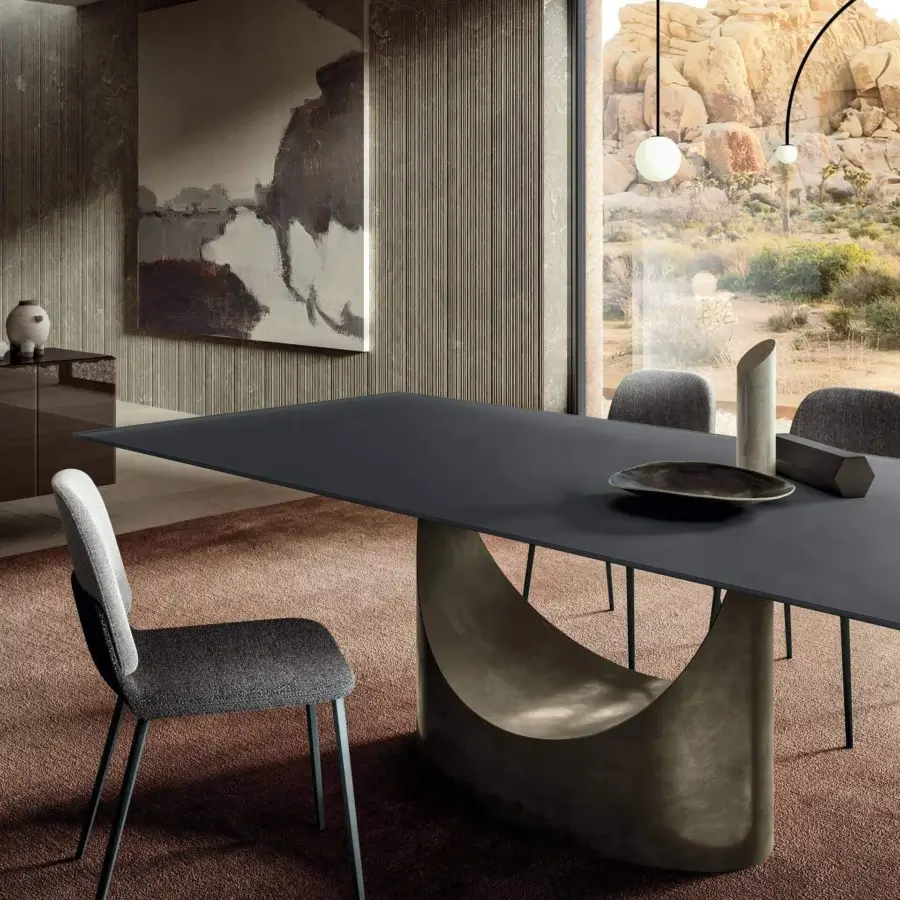Exceptional Lago U Rectangular table with a dark tabletop and curved crescent base in a textured finish