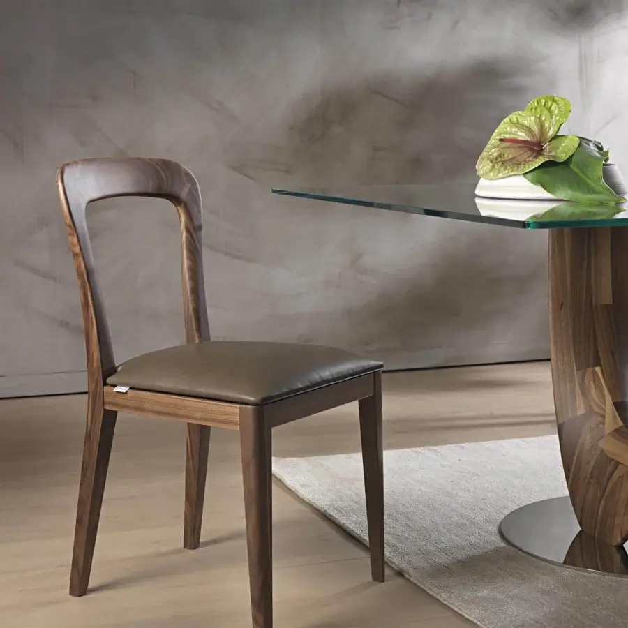 Distinguished Pacini & Cappellini Gaya chair crafted with dark brown leather and a solid Canaletto walnut frame exhibiting balanced geometric forms