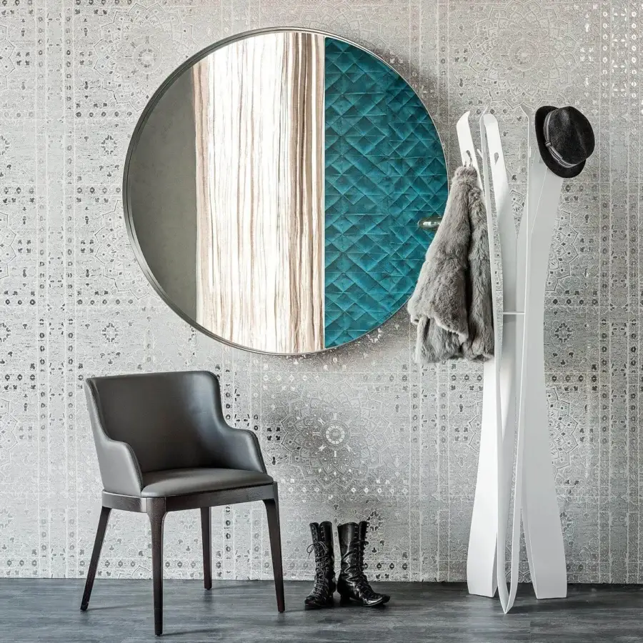 Elegant Cattelan Italia Wish mirror with circular reflective surface in graphite embossed lacquered steel frame