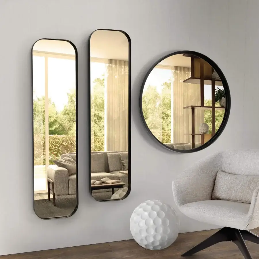 Distinguished Pacini & Cappellini Ron mirror with a sleek dark matte metal frame reflecting a curated interior