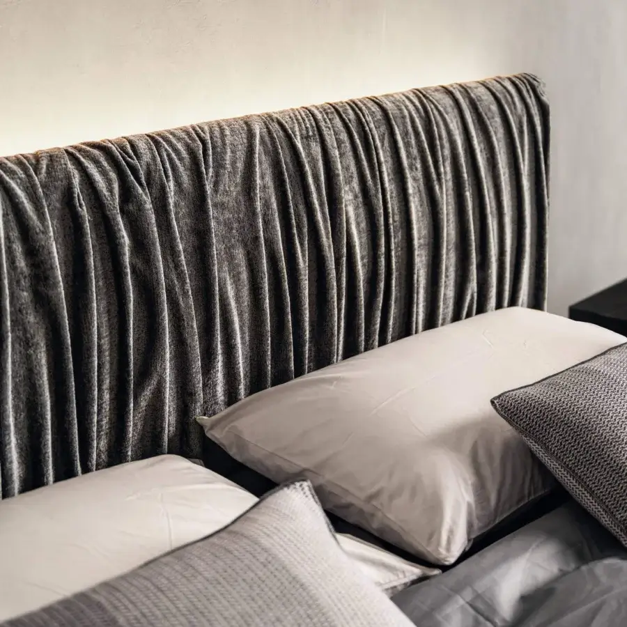 Distinguished Lago Air Replis bed with extra-clear tempered glass supports and dark gray textile headboard crafted with vertical pleats
