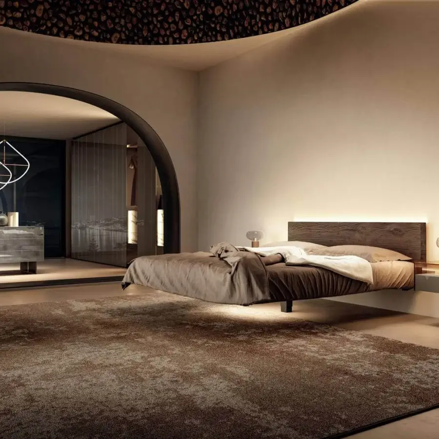 Distinguished Lago Fluttua bed with a wooden headboard and smooth matte grey frame, complemented by warm brown textile bedding