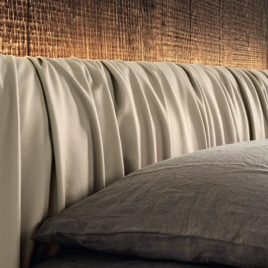 Innovative Lago Fluttua bed with a draped headboard in light neutral synthetic material and matte finish
