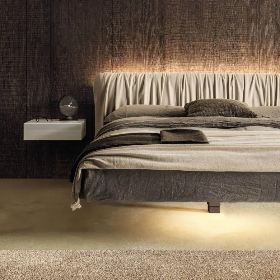 Superior Lago Fluttua bed with a central support and HPL base upholstered in light beige and darker grey textile finishes