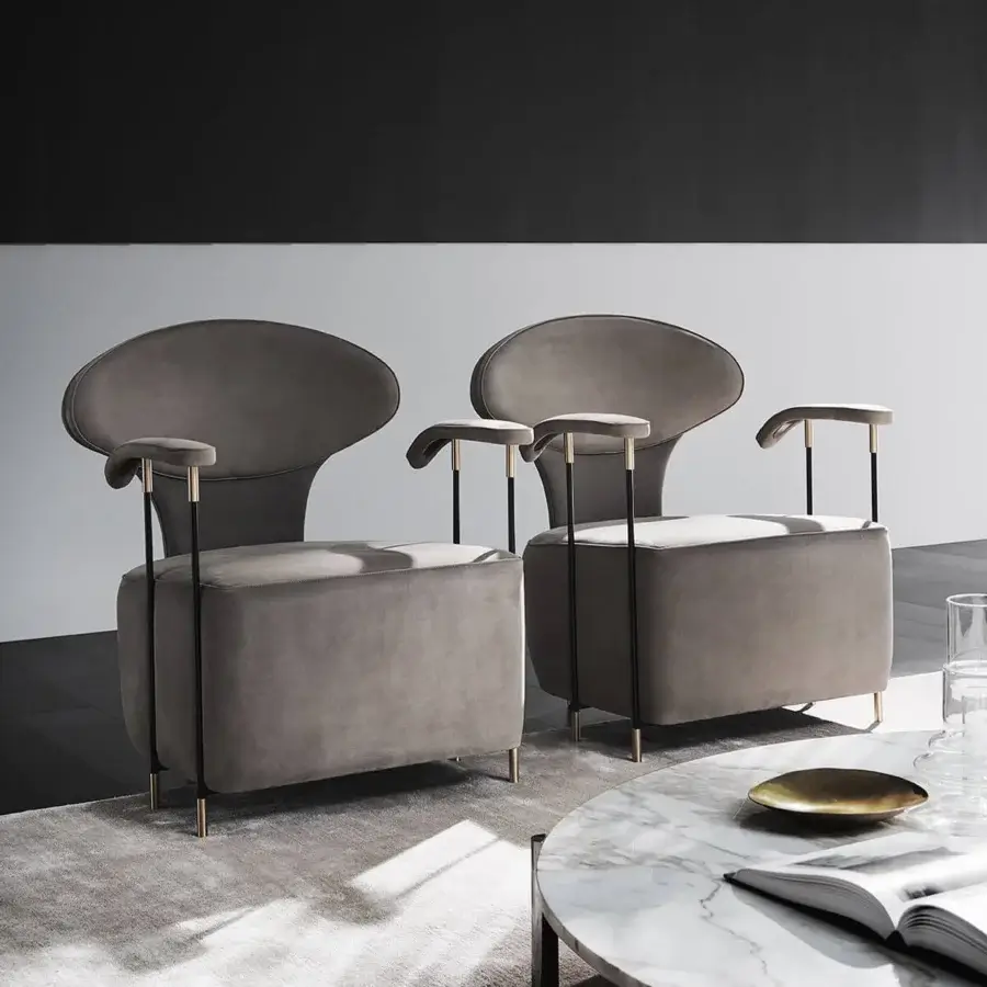 Superior Mascheroni Magicabula lounge chair with rounded geometric forms and muted gray textile upholstery crafted with black steel and precious brass feet