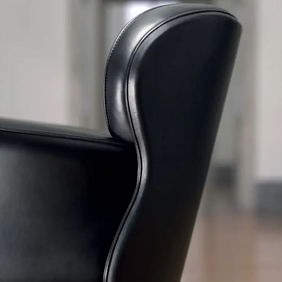 Exceptional Mascheroni Utopias armchair crafted in black material with a gracefully curved backrest and subtle linear detail