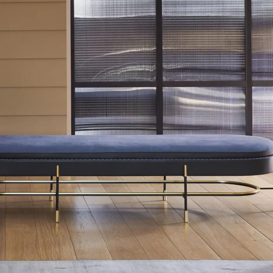 Lavish Mascheroni Circe bench with enveloping blue leather and contrast hand stitching supported by a dark metal structure with brass feet