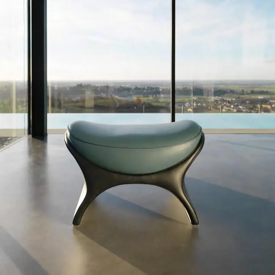Superior Mascheroni La Goccia ottoman crafted with light blue upholstery and glossy dark-toned curved base