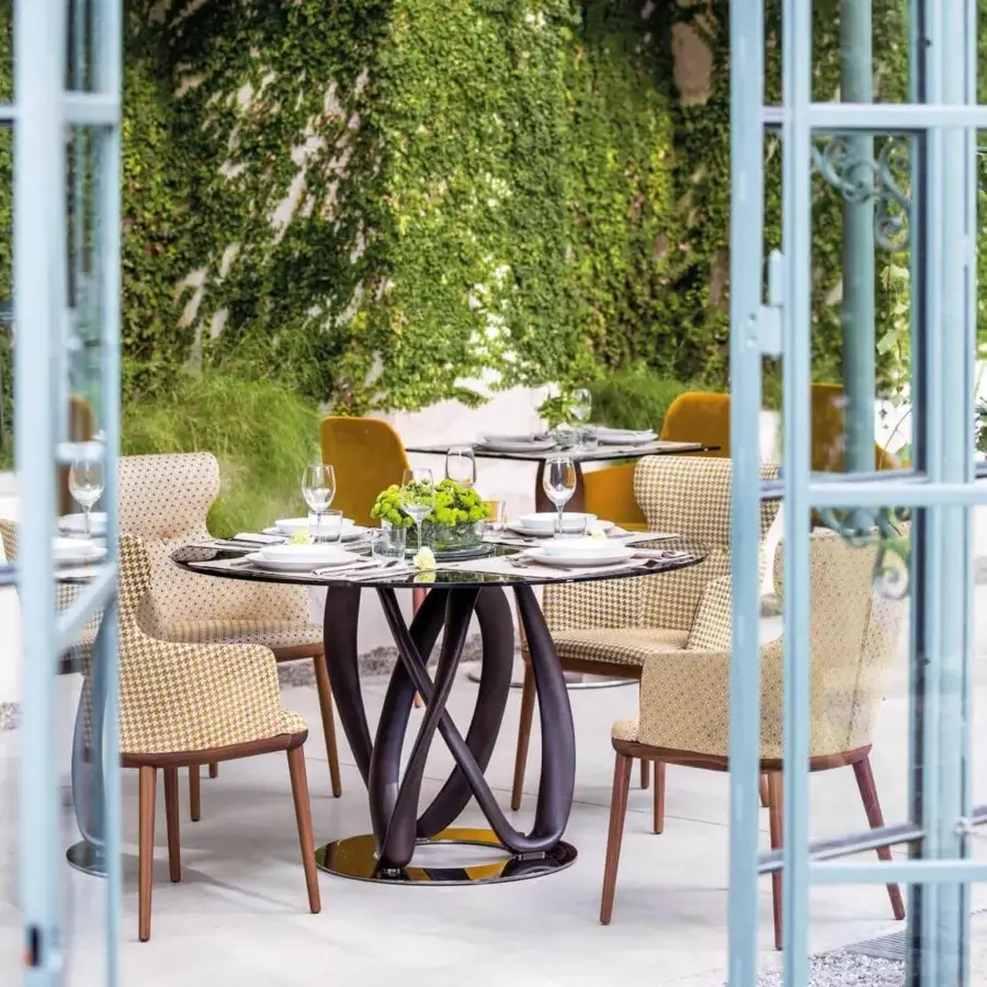 Elegant Porada Infinity table with clear tempered glass poised atop a Canaletto walnut base in wengé finish