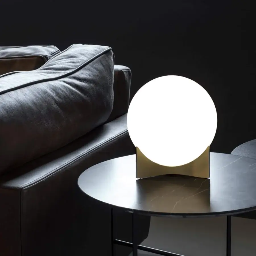 Innovative Terzani Oscar lamp with a white glass orb held by a curved golden-toned metal structure