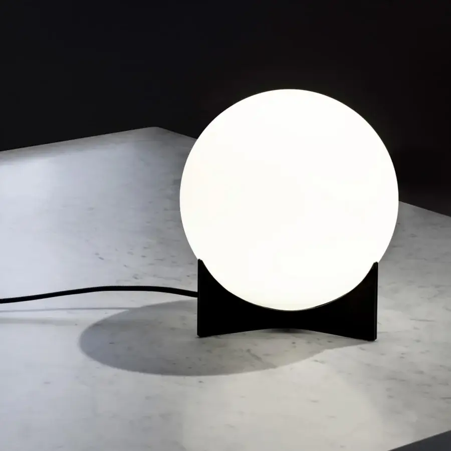 Distinguished Terzani Oscar lamp with a luminous white glass orb supported by a curved matte black structure