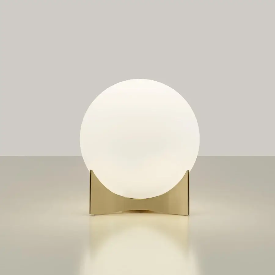 Distinguished Terzani Oscar lamp with a curved metal structure holding a white glass orb and glossy golden tone