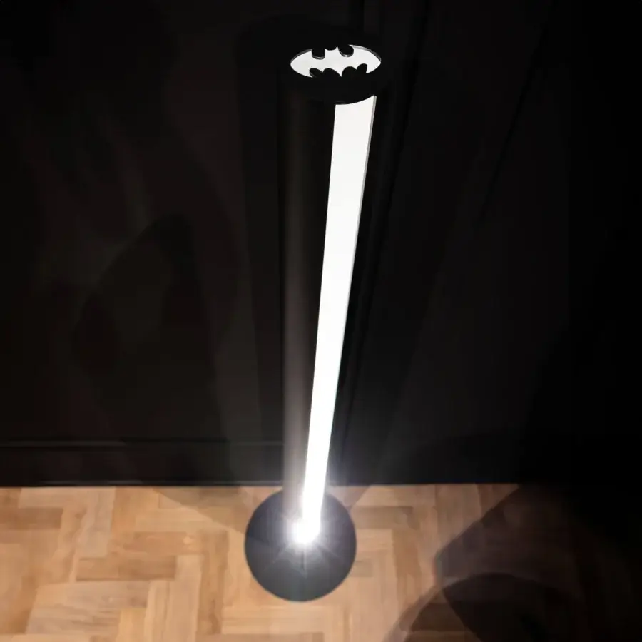 Distinguished WAYNE Enterprises WE-126 floor lamp crafted in Italy with matte black finish embodying a cylindrical shape and iconic batman logo