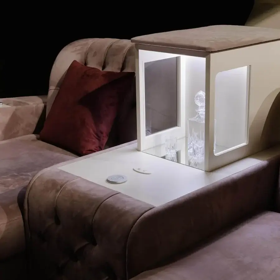 Exceptional Vismara Chest home cinema seating in dusty rose tufted leather with burgundy pillow and soft touch matte lacquered wood side table