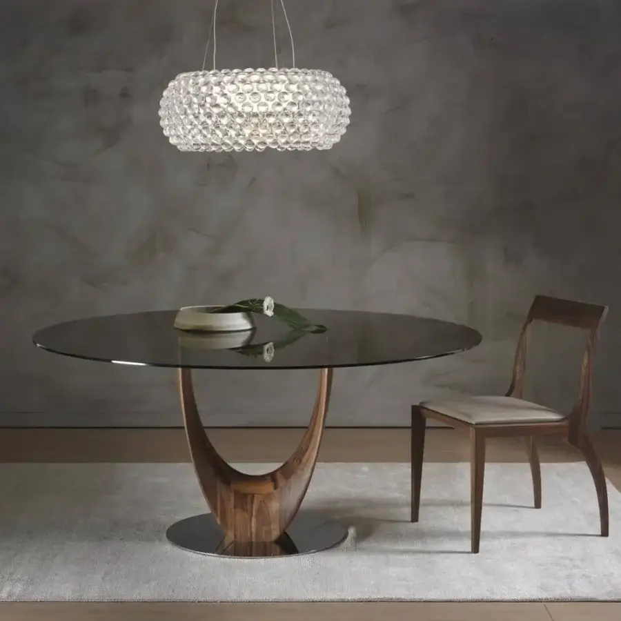 Exceptional Pacini & Cappellini Axis table with tempered glass top and sculptural glossy two-toned brown wood base built with a chromed metal plate