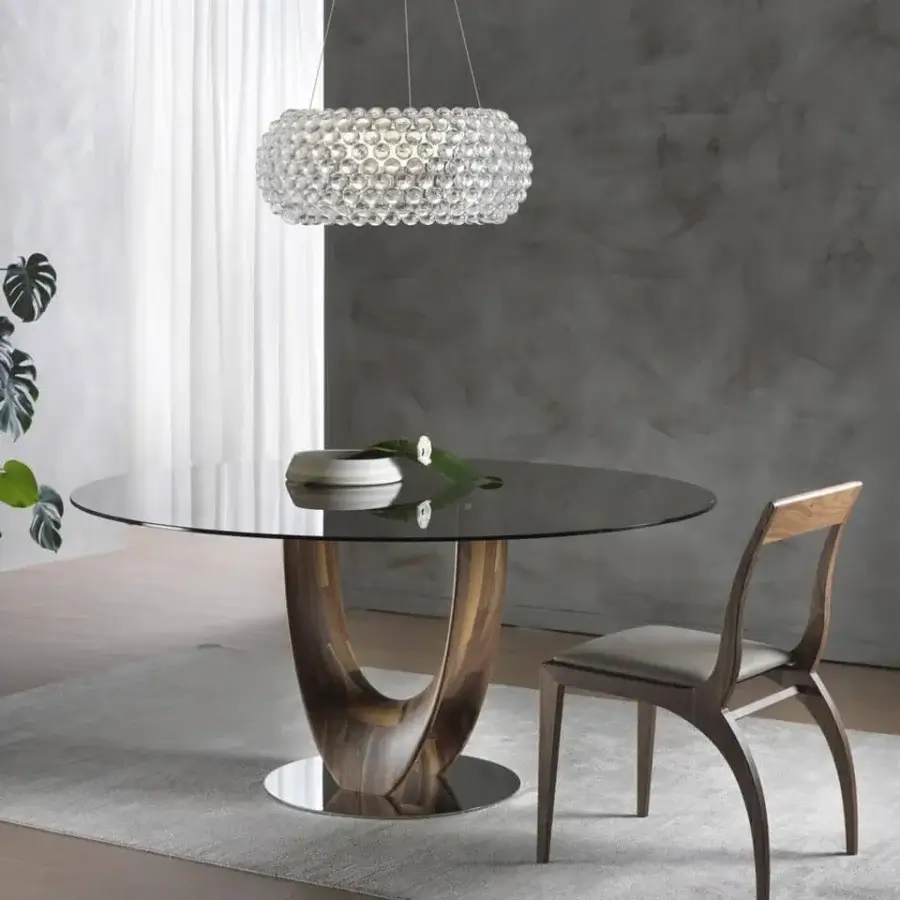 Superior Pacini & Cappellini Axis table with round tempered glass top and sculptural wood base crafted with titanium painted metal