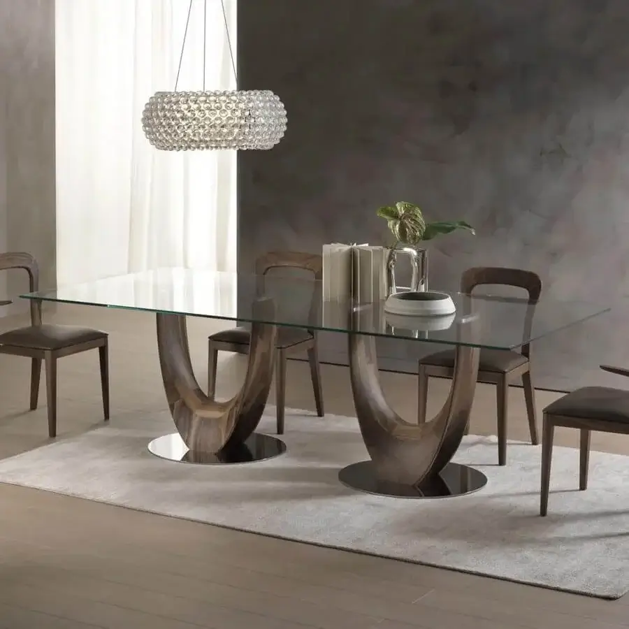 Distinguished Pacini & Cappellini Axis table with a tempered glass top and sculptural medium-toned brown wood base supported by chromed metal plates