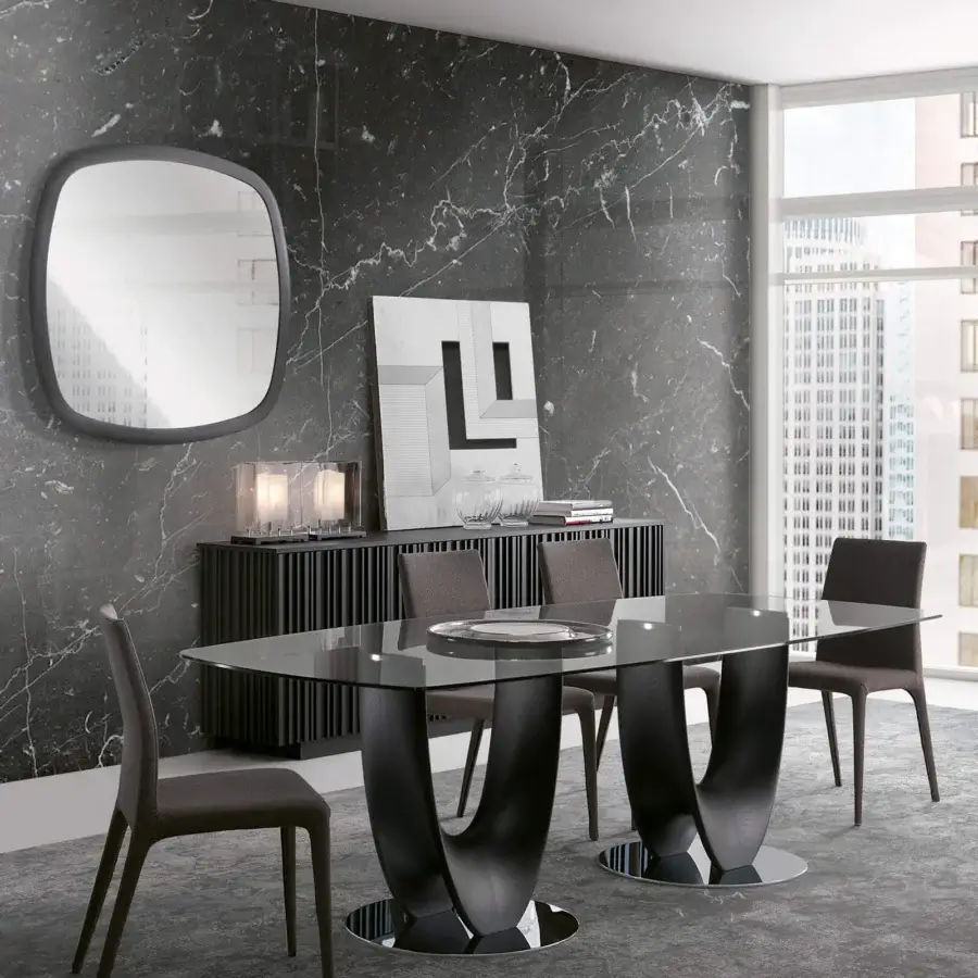 Elegant Pacini & Cappellini Axis table with a tempered glass top and dark finished sculptural wooden bases accented with chromed metal