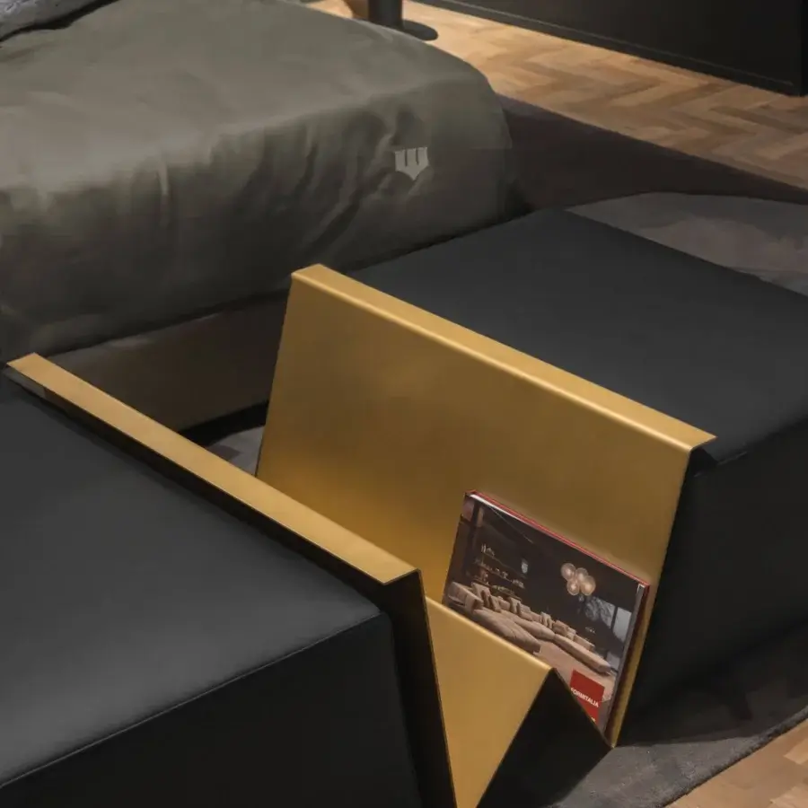 Exclusive WAYNE Enterprises WE-158 ottoman in black upholstery with a gleaming golden metal magazine rack built in