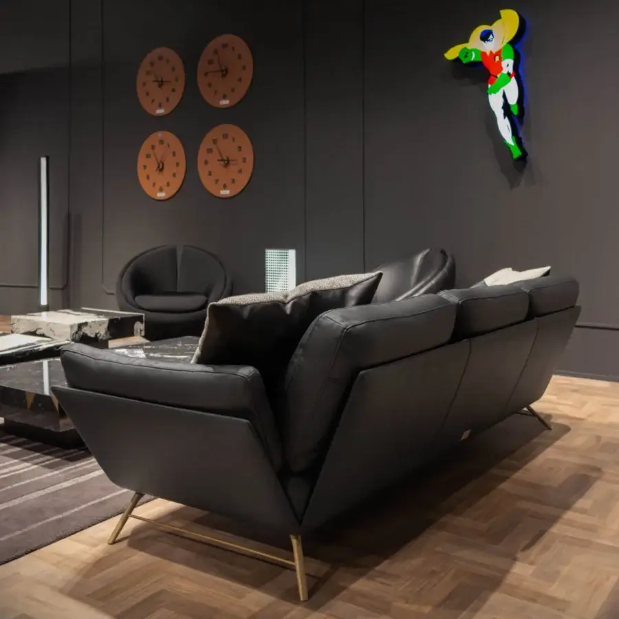 Exclusive WAYNE Enterprises WE-001 sofa upholstered in dark leather with matte finish and slender gold metal feet