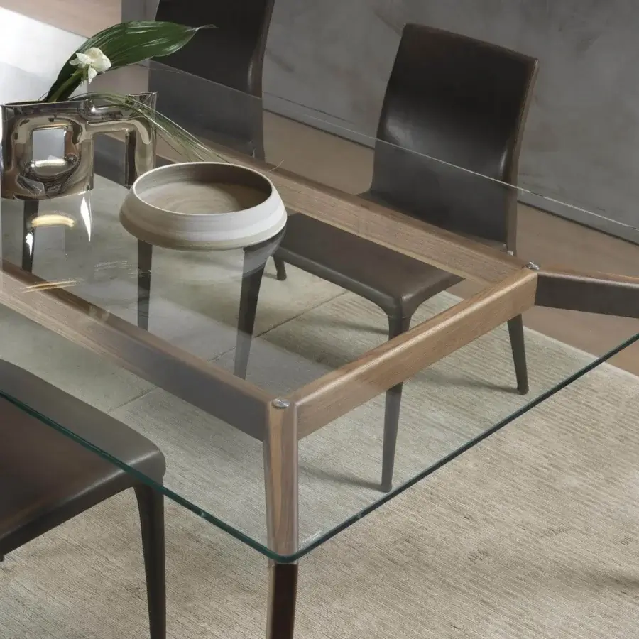 Elegant Pacini & Cappellini Hope table with a transparent glass top revealing a light brown smooth wooden frame and darker wood grain legs