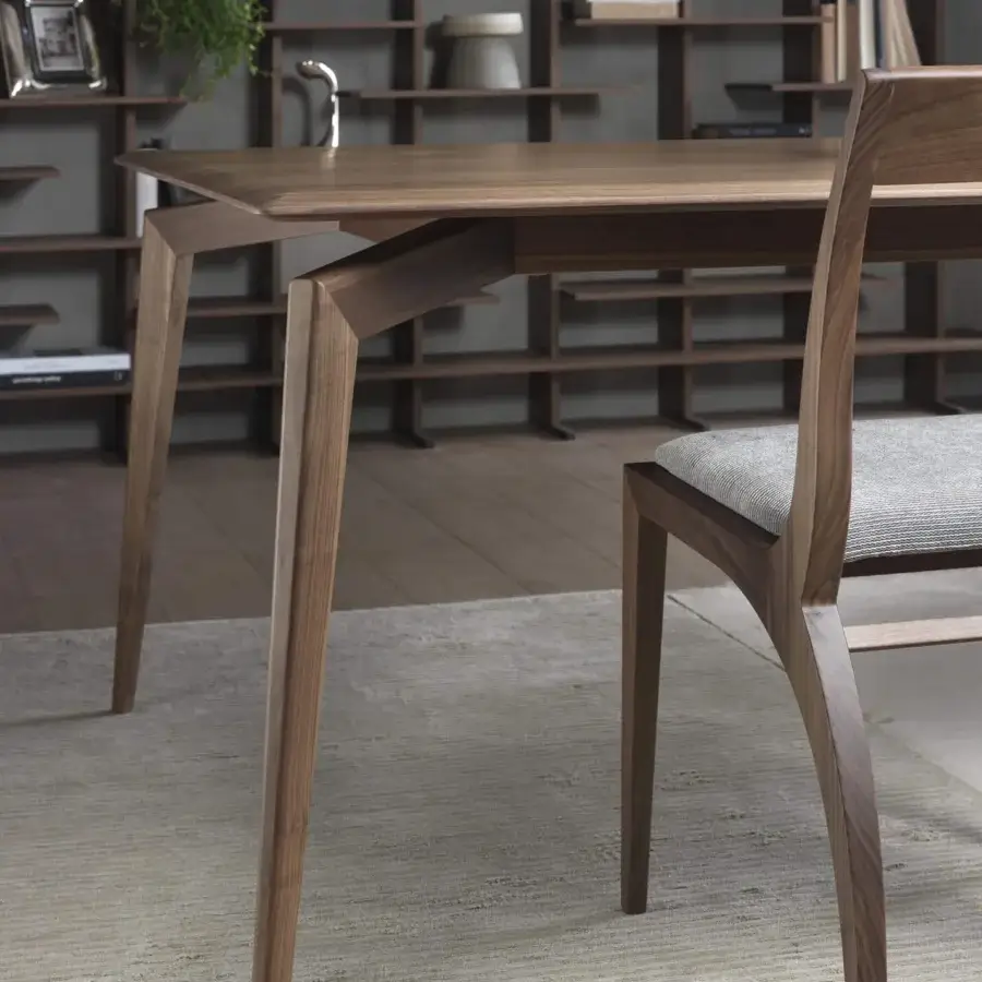 Superior Pacini & Cappellini Hope table crafted in warm brown wood with uniquely angled legs and a coordinating light grey textile chair
