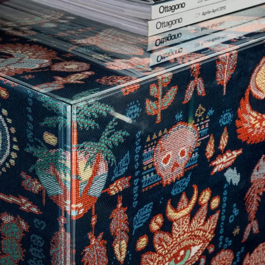 Captivating Lago Materia cupboard with a textile finish displaying skulls, eyes, plants and abstract shapes in orange, yellow, blue and green hues