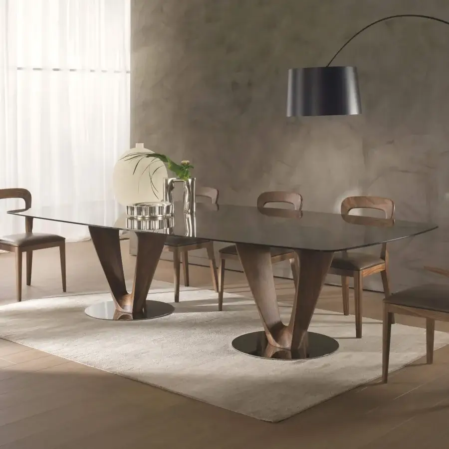 Distinguished Pacini & Cappellini Mobius table with clear tempered glass top and sinuous V-shaped wooden bases built with chromed metal plates