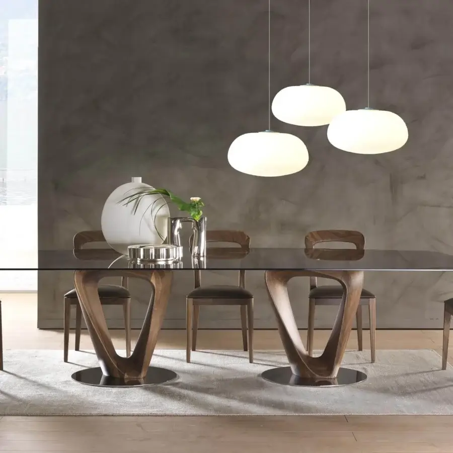 Superior Pacini & Cappellini Mobius table with sleek tempered glass top and sinuous wooden elements mounted on chromed metal plates
