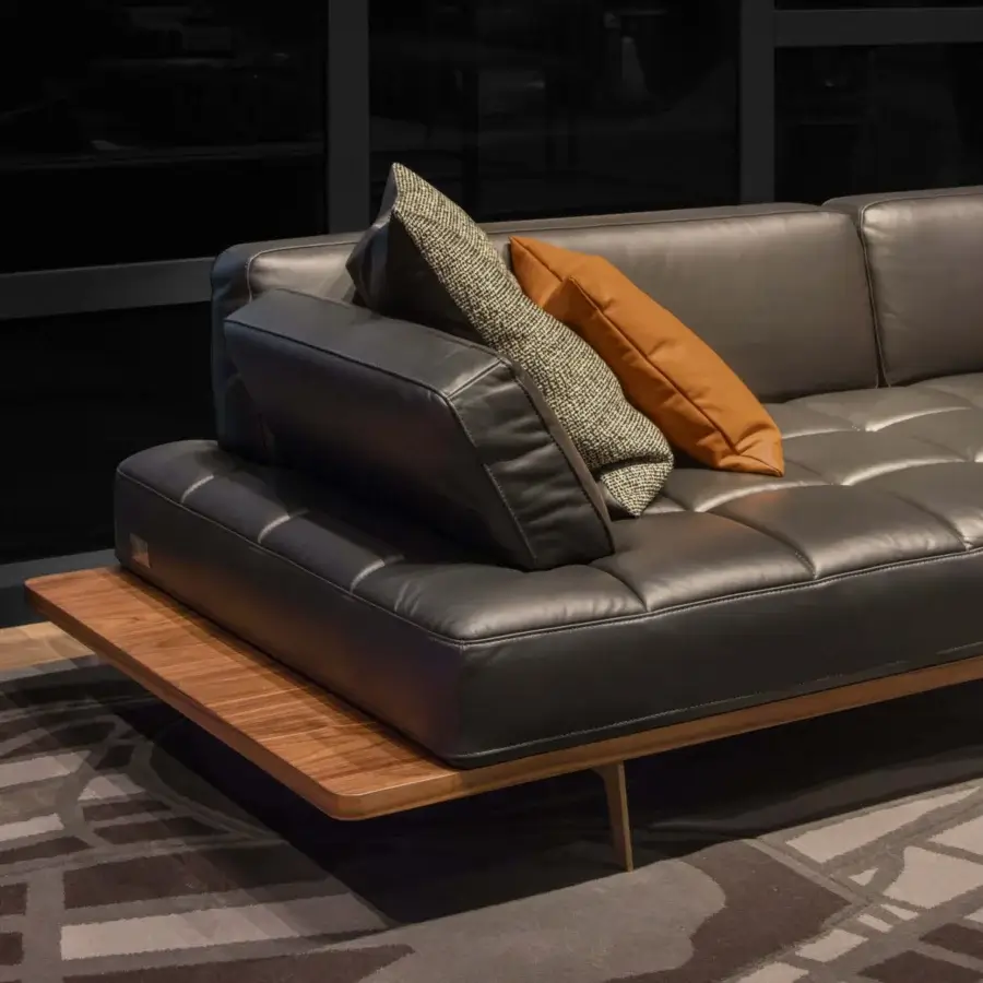 Superior WAYNE Enterprises WE-029 sofa in smooth dark gray leather with a wood veneer base and sleek metal feet