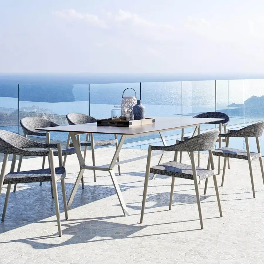 Distinguished Varaschin Clever armchair with a powder-coated aluminum frame and durable VAR#TEX woven seat in a muted grey tone