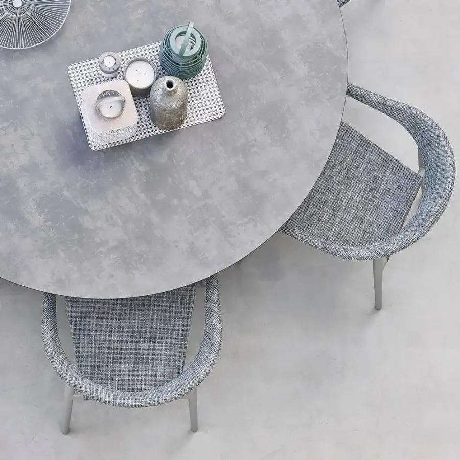 Elegant Varaschin Clever armchair with a powder-coated aluminum frame and durable VAR#TEX woven seat in a muted blue-grey hue