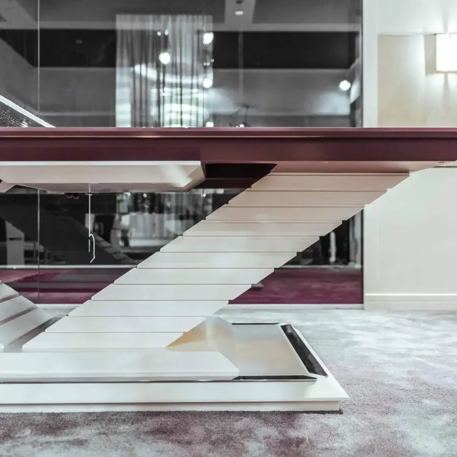 Distinguished Vismara Arena table tennis table with burgundy top and lacquered V-shaped base crafted in polished chrome steel details