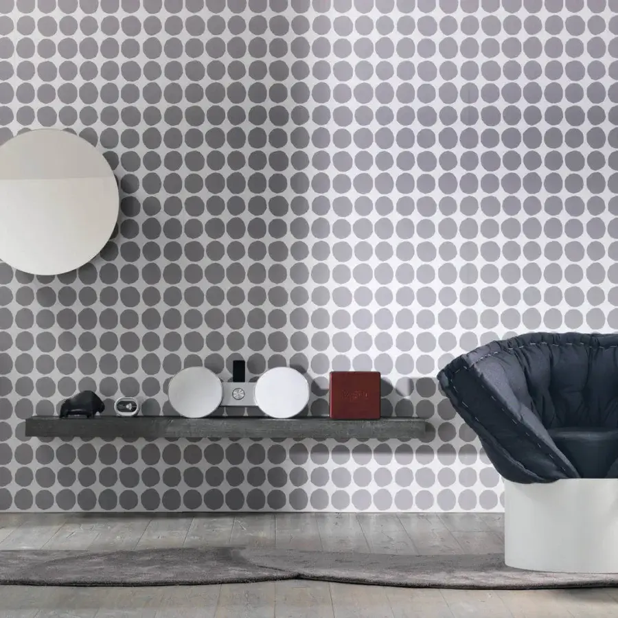 Innovative Lago Huggy lounge chair in deeply quilted dark blue-gray Patchwork fabric with matte white cylindrical base