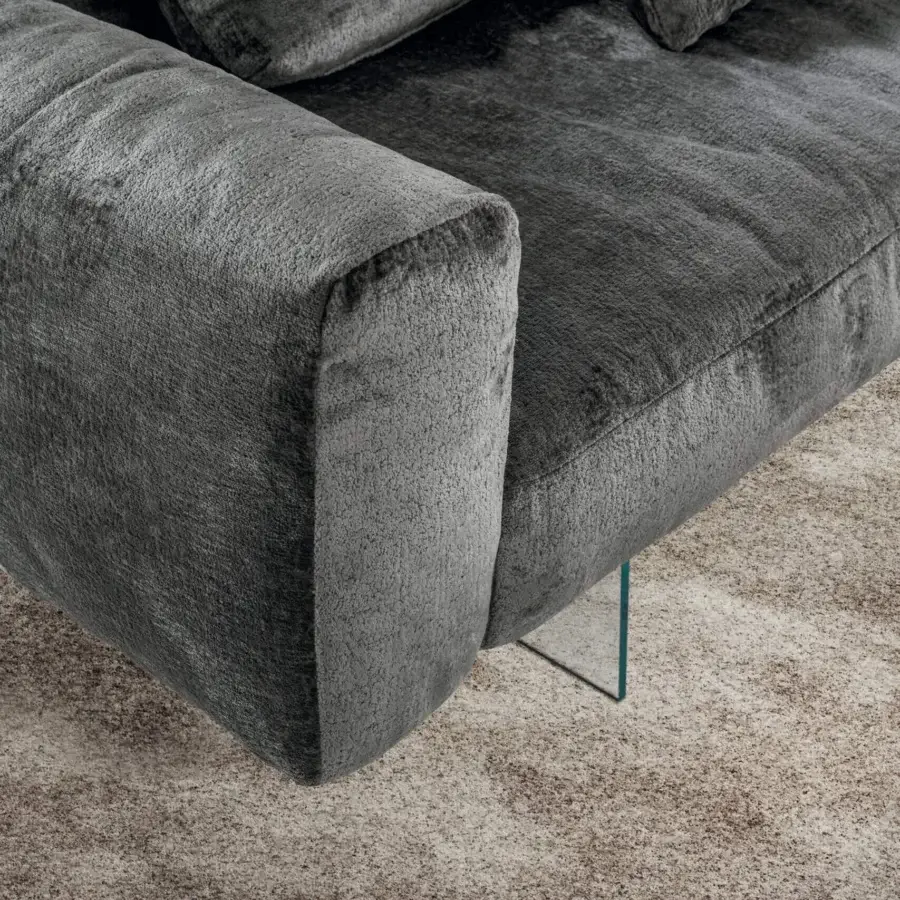 Innovative Lago Air Soft sofa with soft forms and a transparent glass support built in uniform gray textile with textured finish