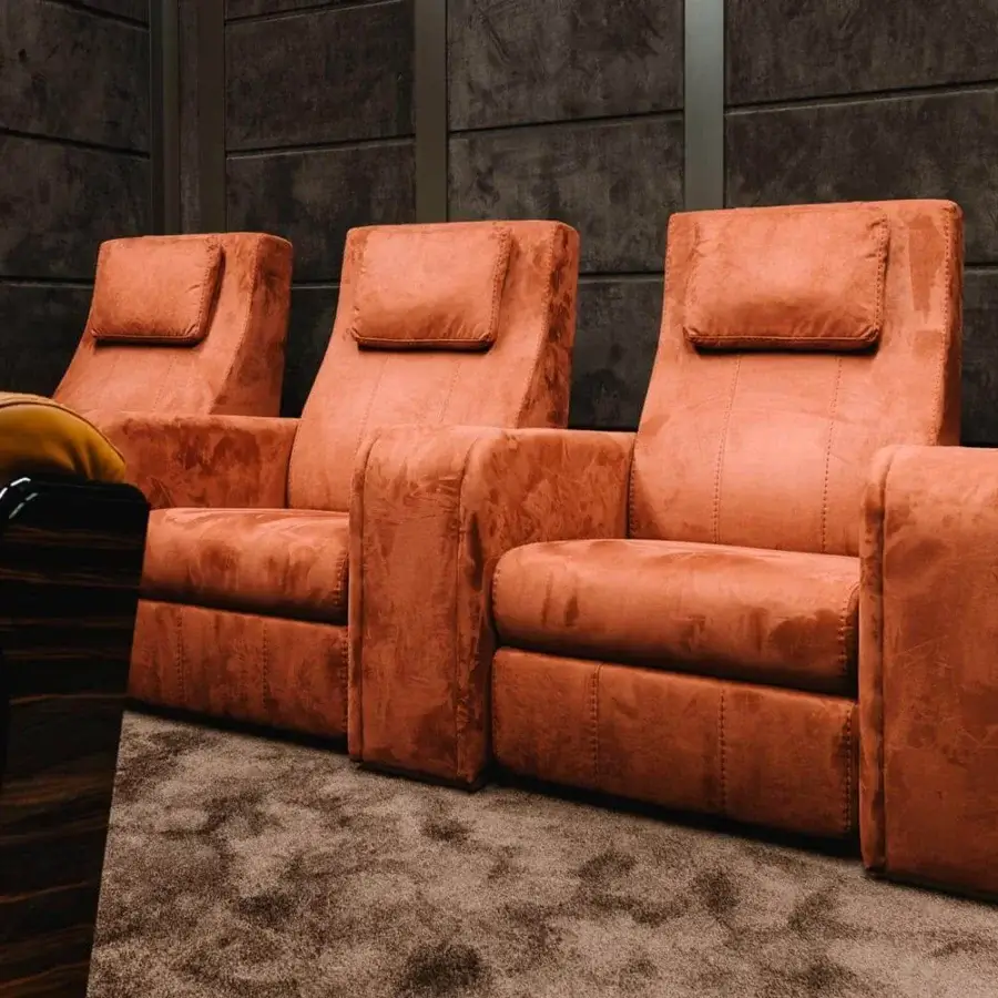 Lavish Vismara Comfort home cinema seating in reddish-orange textured fabric with soft-touch lacquered wood controls