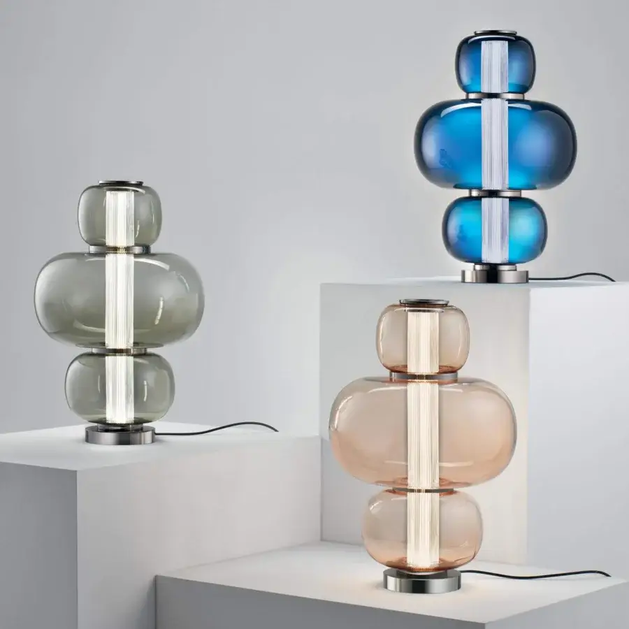 Captivating Italamp Nube lamp with stacked rounded glass sections and iron grey metal accents, built with a hand-carved crystal diffuser