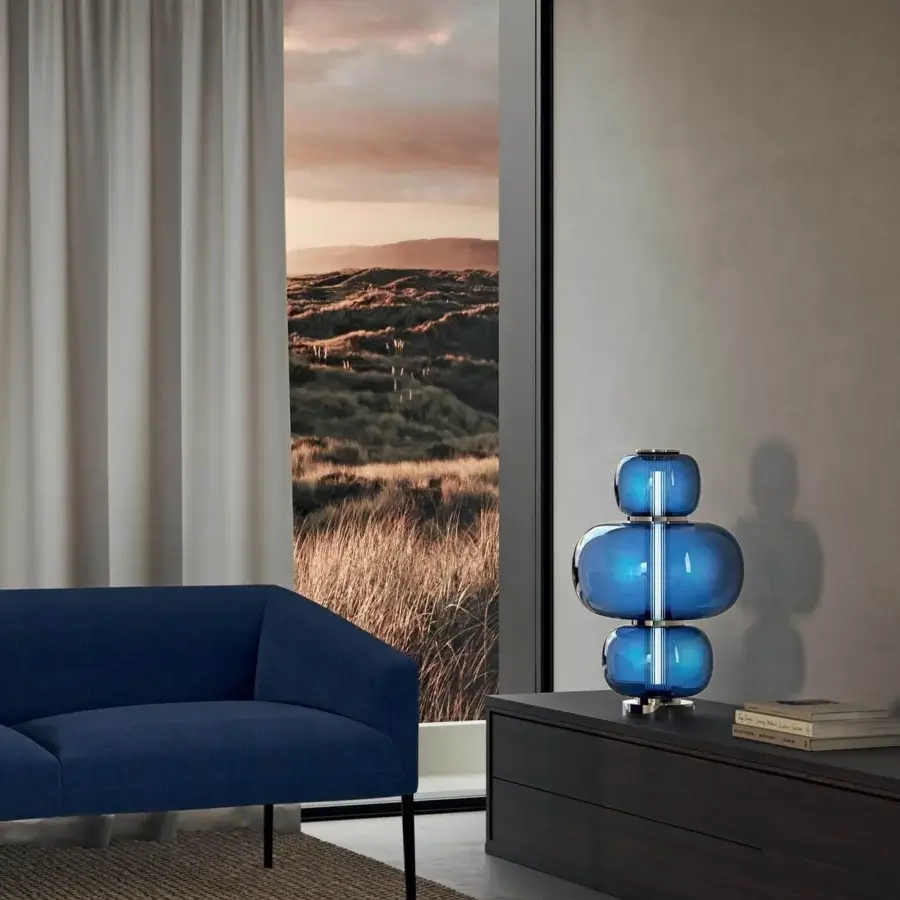 Superior Italamp Nube lamp with vibrant blue glass surrounding a hand-carved crystal diffuser and iron grey finish