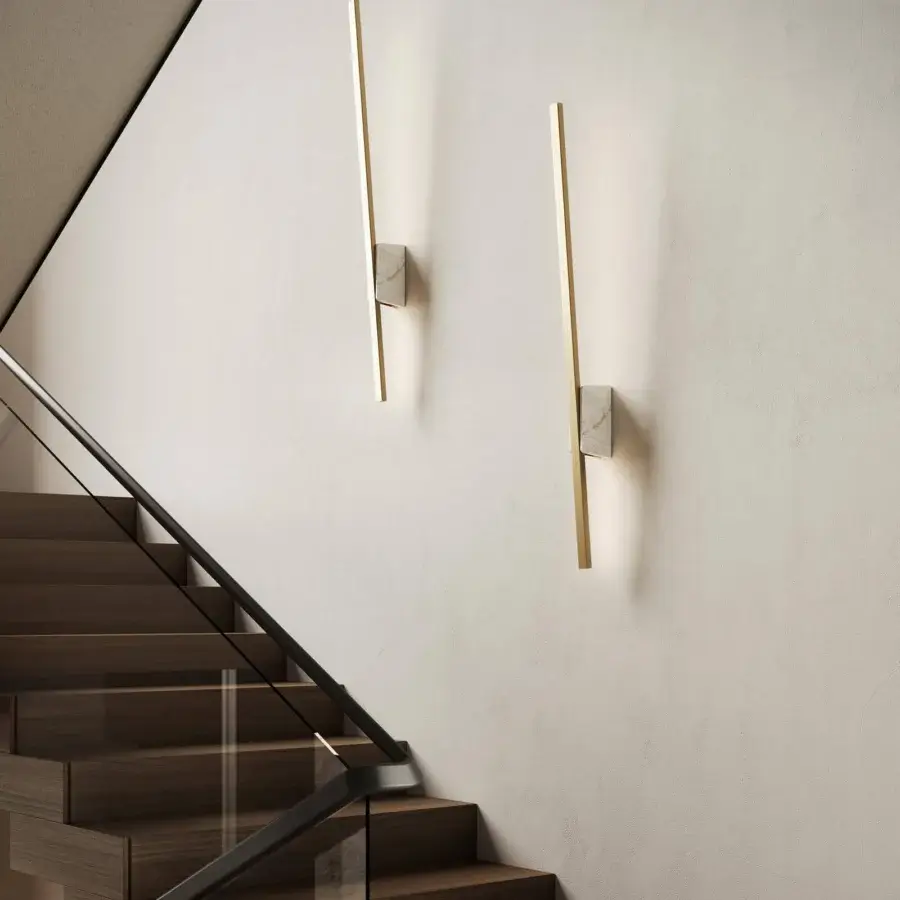 Distinguished Italamp Regolo wall lamp with golden metal and refined marble, emitting warm 3000K LED light through a methacrylate shade